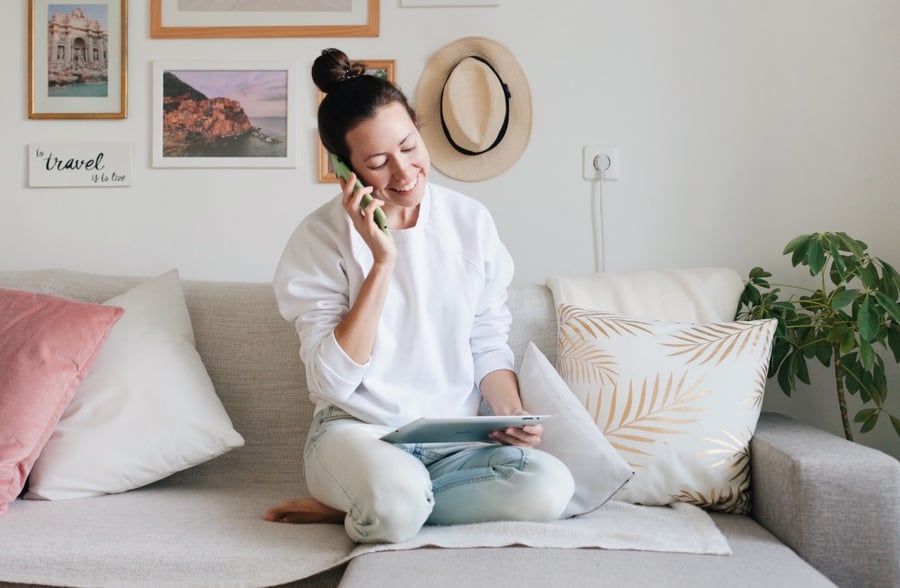 a-young-woman-wearing-white-sweatshirt-and-blue-jeans-is-working-from-home-using-a-mobile-phone-and-a_t20_VW1RG6