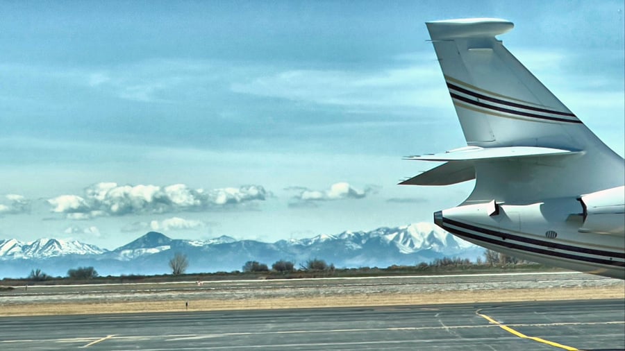 aircraft-aviation-airport-runway-blue-sky-negative-space-private-jet-moutain-range-at-the-airport_t20_mBPBXr