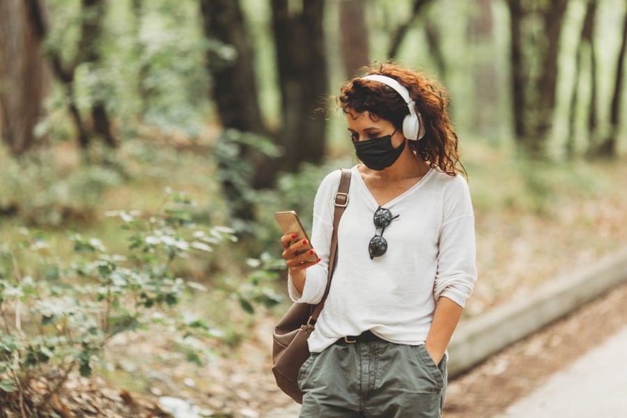 beautiful-young-women-with-phone-walking-in-park-or-forest-in-black-mask_t20_gLz7zk (1)