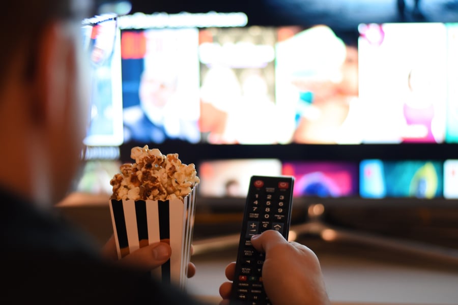 movie-night-watching-tv-television-popcorn-netflix-and-chill-remote-control-hands-holding-at-home_t20_rLlaag